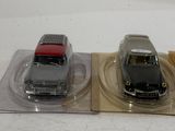 three toy cars sitting on top of a plastic tray