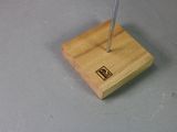 a small wooden stand with a pen on top of it