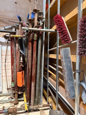 a lot of tools that are hanging on the wall