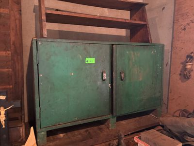 a green cabinet in the corner of a room