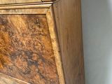 a wooden cabinet with a drawer on top of it