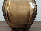 a brown glass bowl sitting on a wooden table