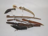 many different types of knives on a white surface