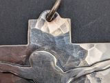 an image of a silver cross with a man on it