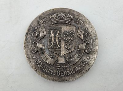 an old silver coin with a coat of arms and a crown on it