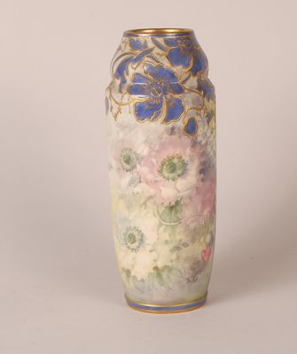 a vase with a floral design on it sitting on a table
