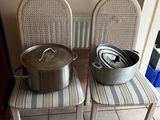 two chairs that have pots on them on them