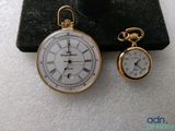 a gold pocket watch and a gold pocket watch on display