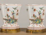 two vases that are sitting on a table