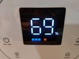 a digital clock that is on the side of a microwave
