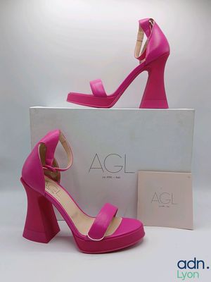 a close up of a pair of pink high heeled sandals
