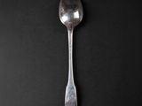 a spoon that is sitting on a black surface