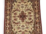 a red and beige rug with a floral design on it
