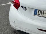 a white car parked in a parking lot next to a building
