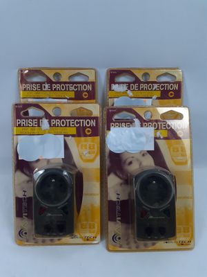 pair of two black plastic cameras sitting on top of a white table