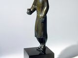 bronze statue of a man with a cup of coffee on a pedestal