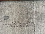 a wooden bench sitting on the side of the street