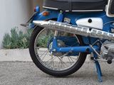 a blue motorcycle parked in front of a building