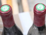two bottles of wine sitting next to each other on a table