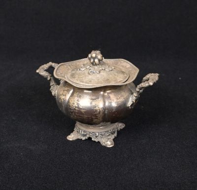 an antique silverplated sugar dish with a lid and handles