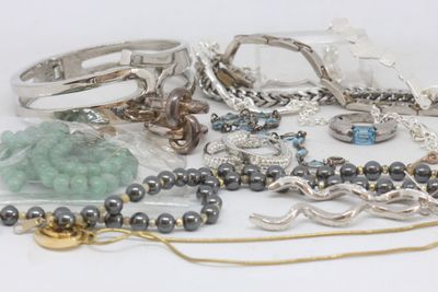 many different types of jewelry on a white surface