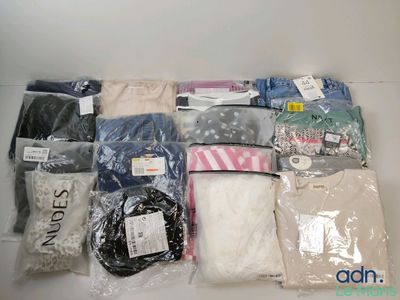 a lot of clothes that are sitting on a table