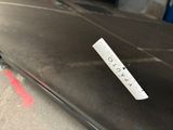 a sticker on the back of a car that is parked
