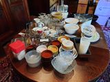 a table with a lot of dishes and bowls on it