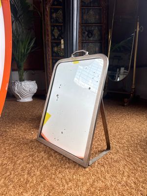 a surfboard sitting on the floor next to a mirror