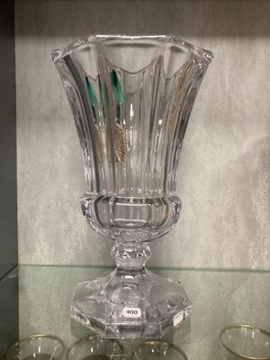 a glass vase sitting on top of a glass shelf