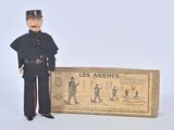 toy figurine of a man in uniform standing next to a box