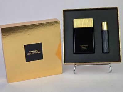 black and gold perfume set in a gold box on a white surface