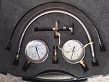 two gauges and a hose in a black case