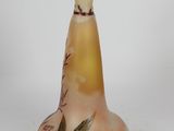 a glass vase with a design on it on a white surface