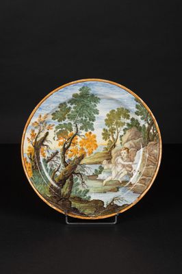 an image of a plate with a painting on it on a black surface