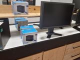 a picture of a desk with a computer monitor and a printer
