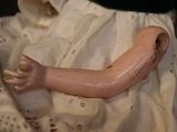 a doll that is laying down on a bed