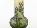 a green vase with a painting of flowers on it