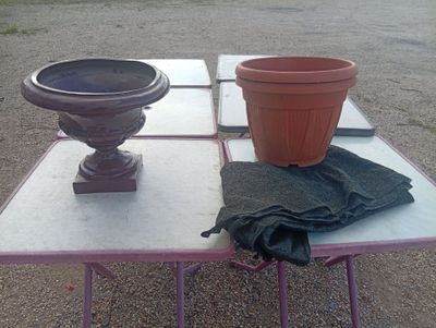 two flower pots on a table with a cloth on it