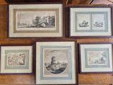 many framed pictures on the wall of a room