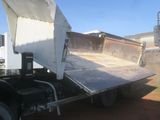 a dump truck that is sitting in the dirt