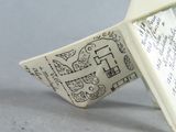 a paper boat with a map on it sitting on a table