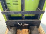 a close up of a forklift with a wooden pallet in the back