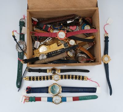 many different watches and bracelets in a box