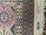 close up of a rug with many different colors and patterns on it
