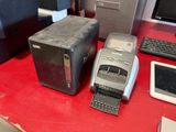 two computers and a printer sitting on a red desk