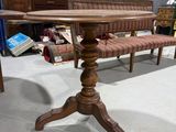a wooden table with a bench in the middle of it