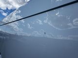 a reflection of the sky on the side of a boat