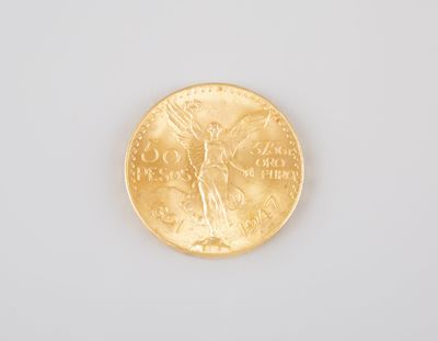 a close up of a gold coin on a white surface