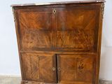 a wooden cabinet with two doors and a drawer on it